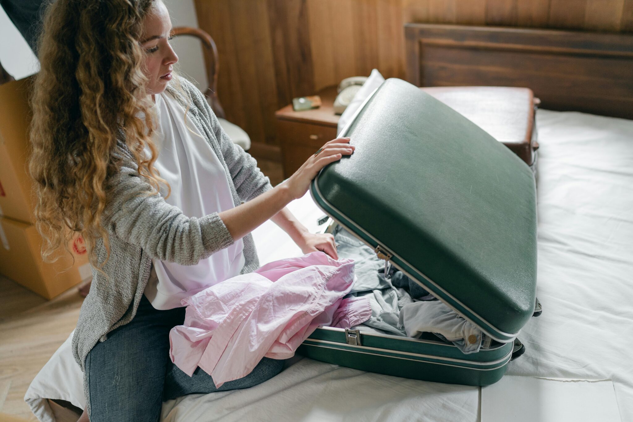 A woman packing a suitcase.