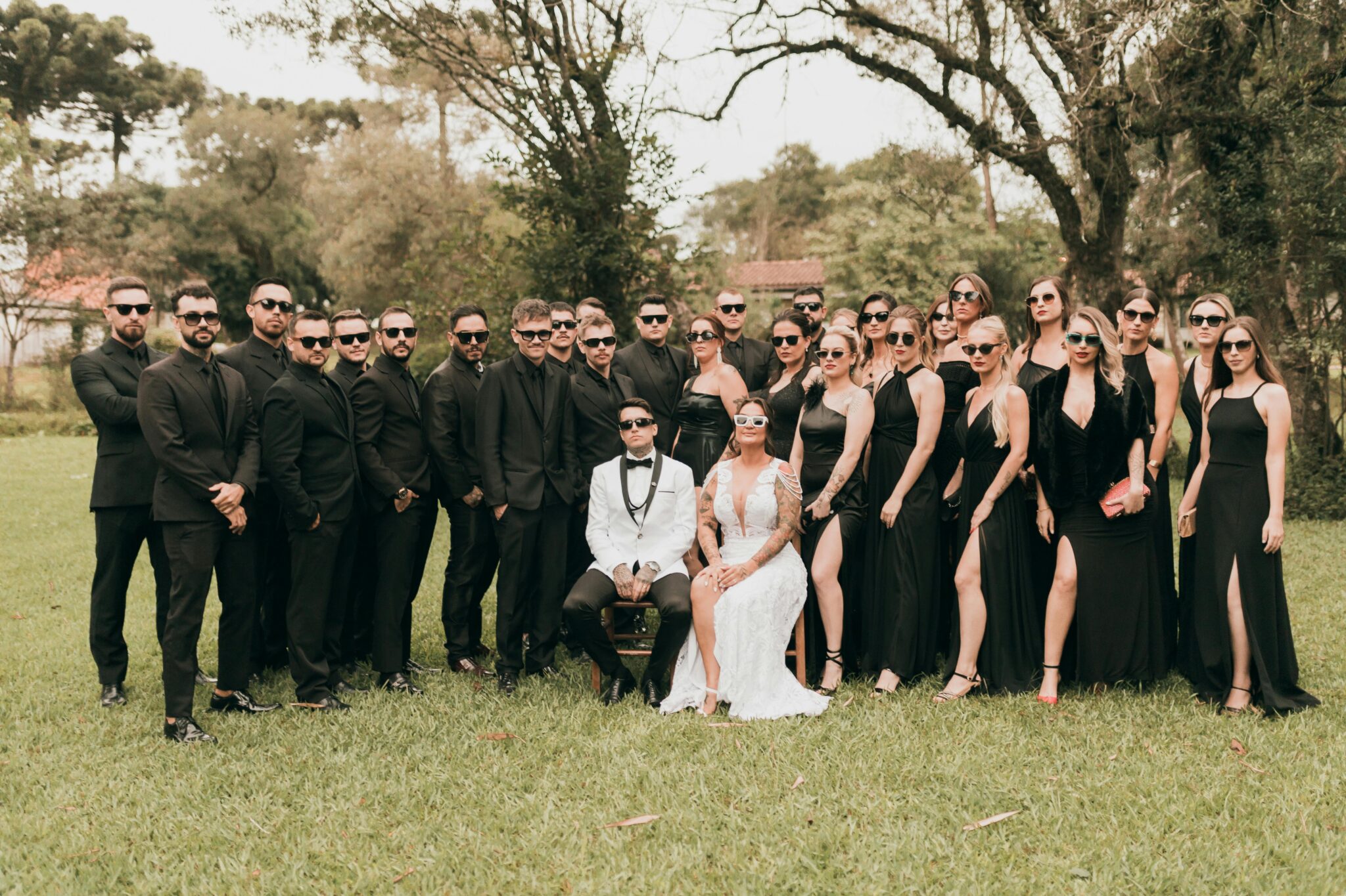 Group of wedding guests and newlyweds dressed in matching colours.