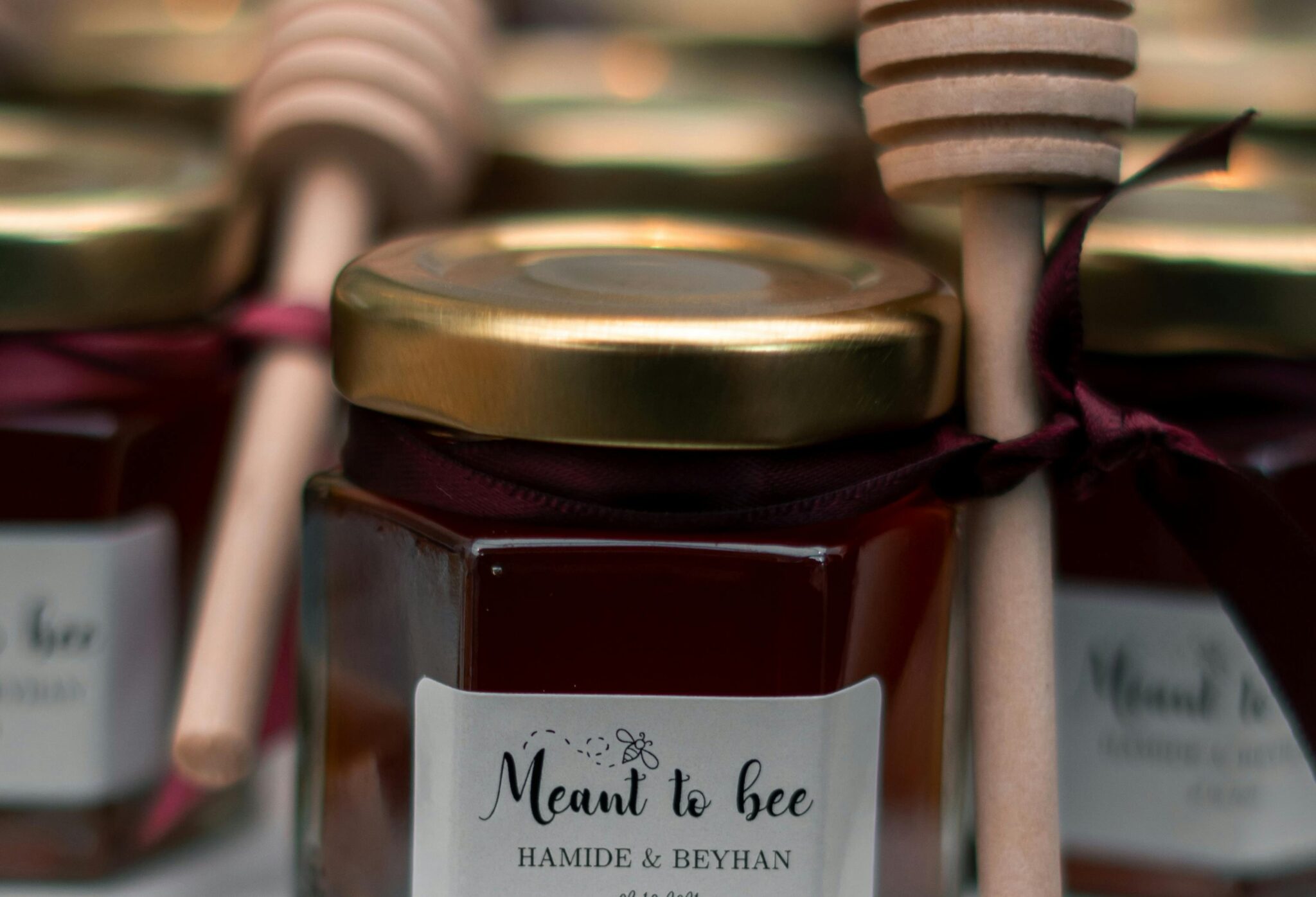 Small honey jars with "meant to bee" written on them.