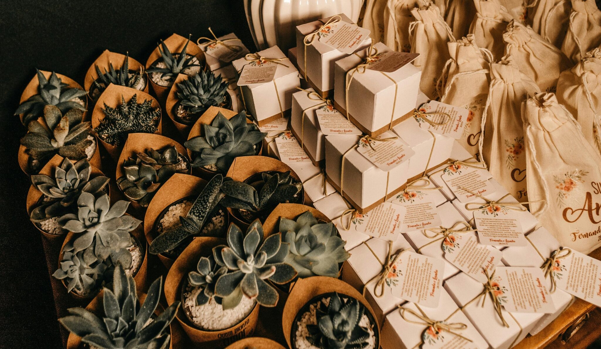 Plants and other wedding favours arranged on a surface.