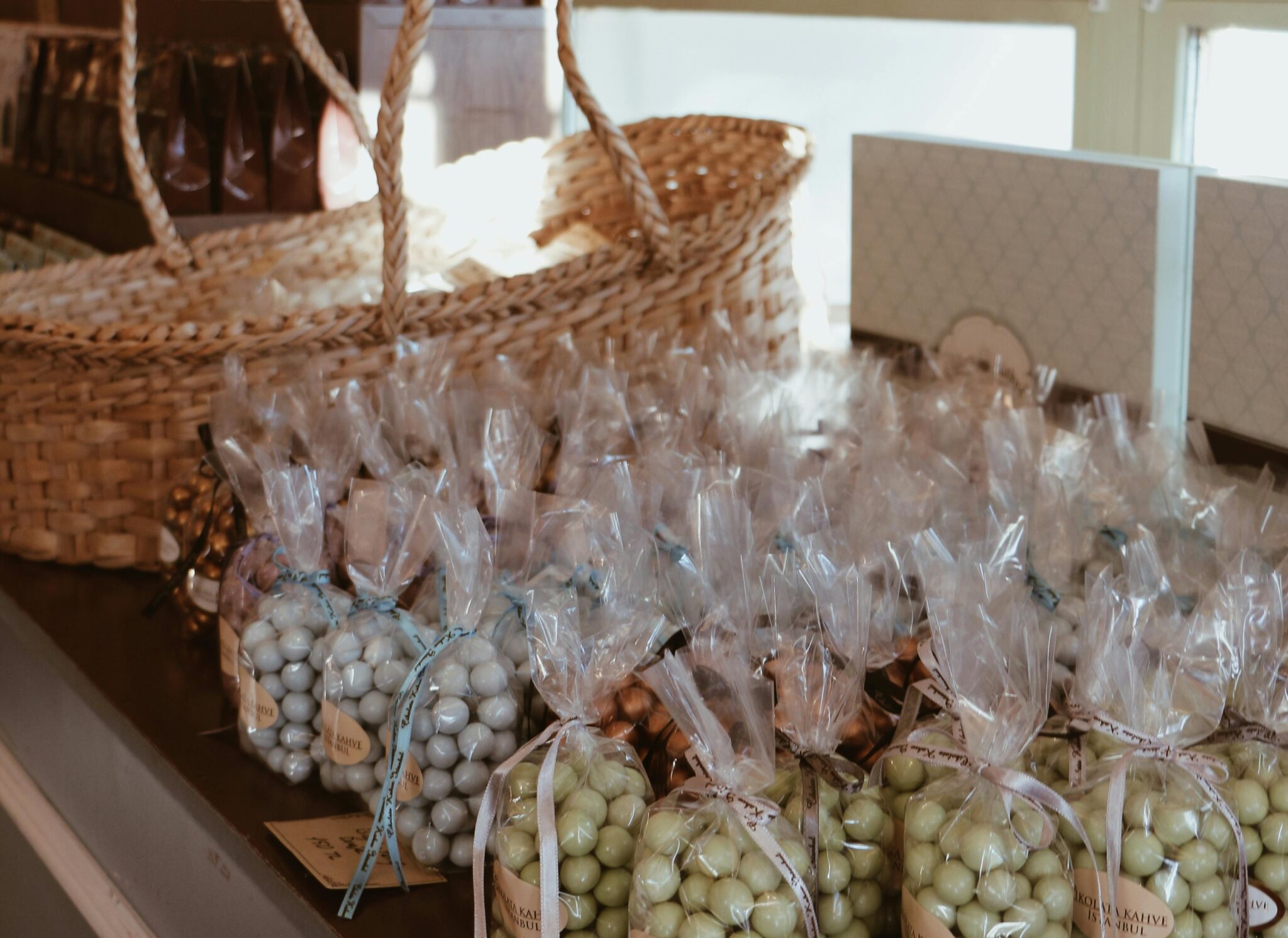 Candied nuts as wedding favours in baggies, placed beside a woven basket.