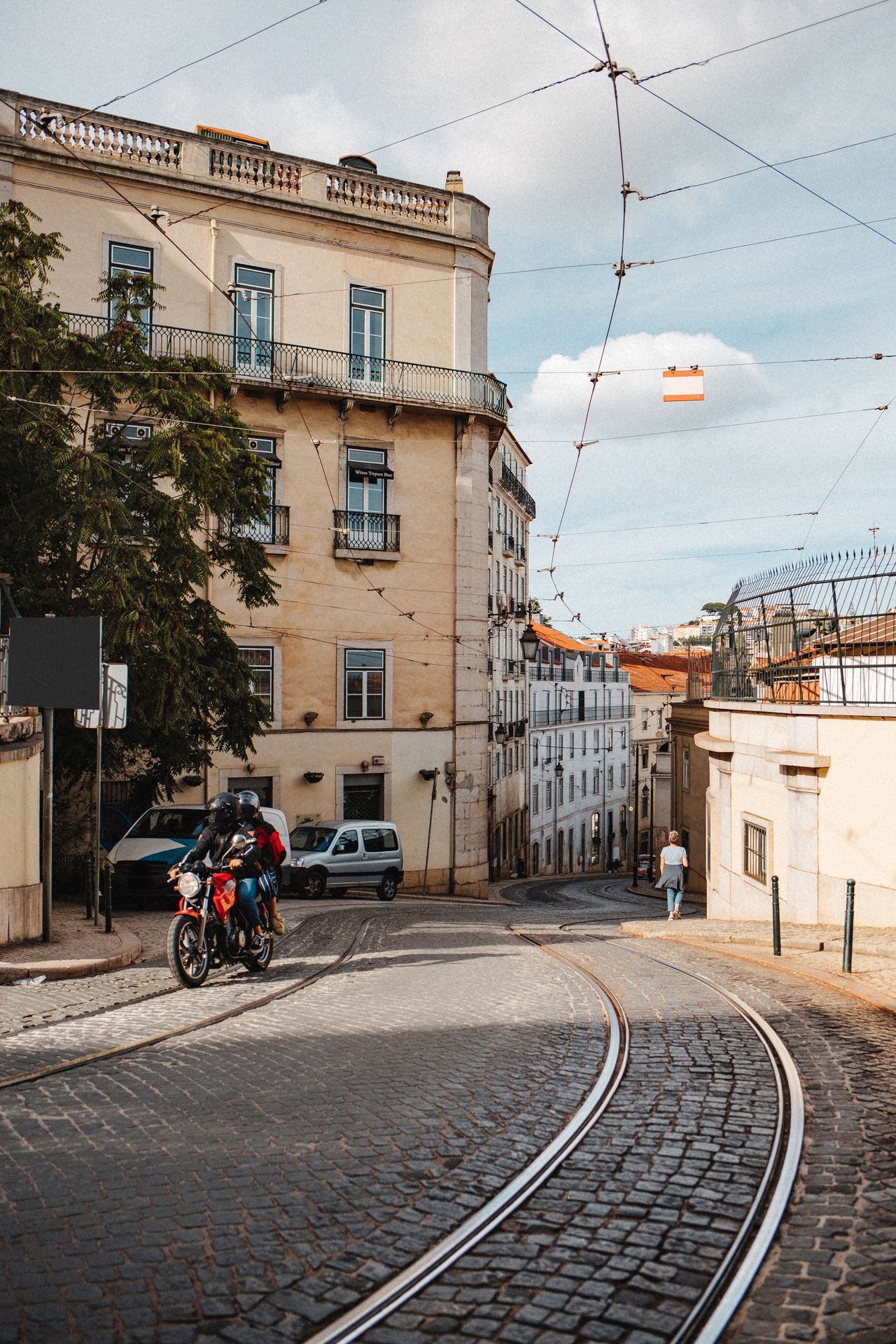 Quite Lisbon city street with tram tracks.