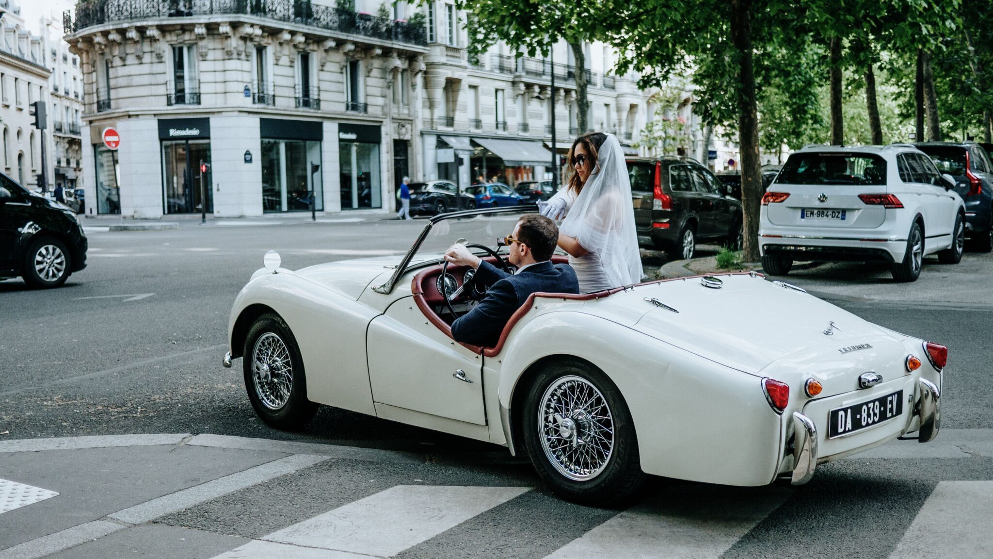 A couple in a vintage car in Paris, France