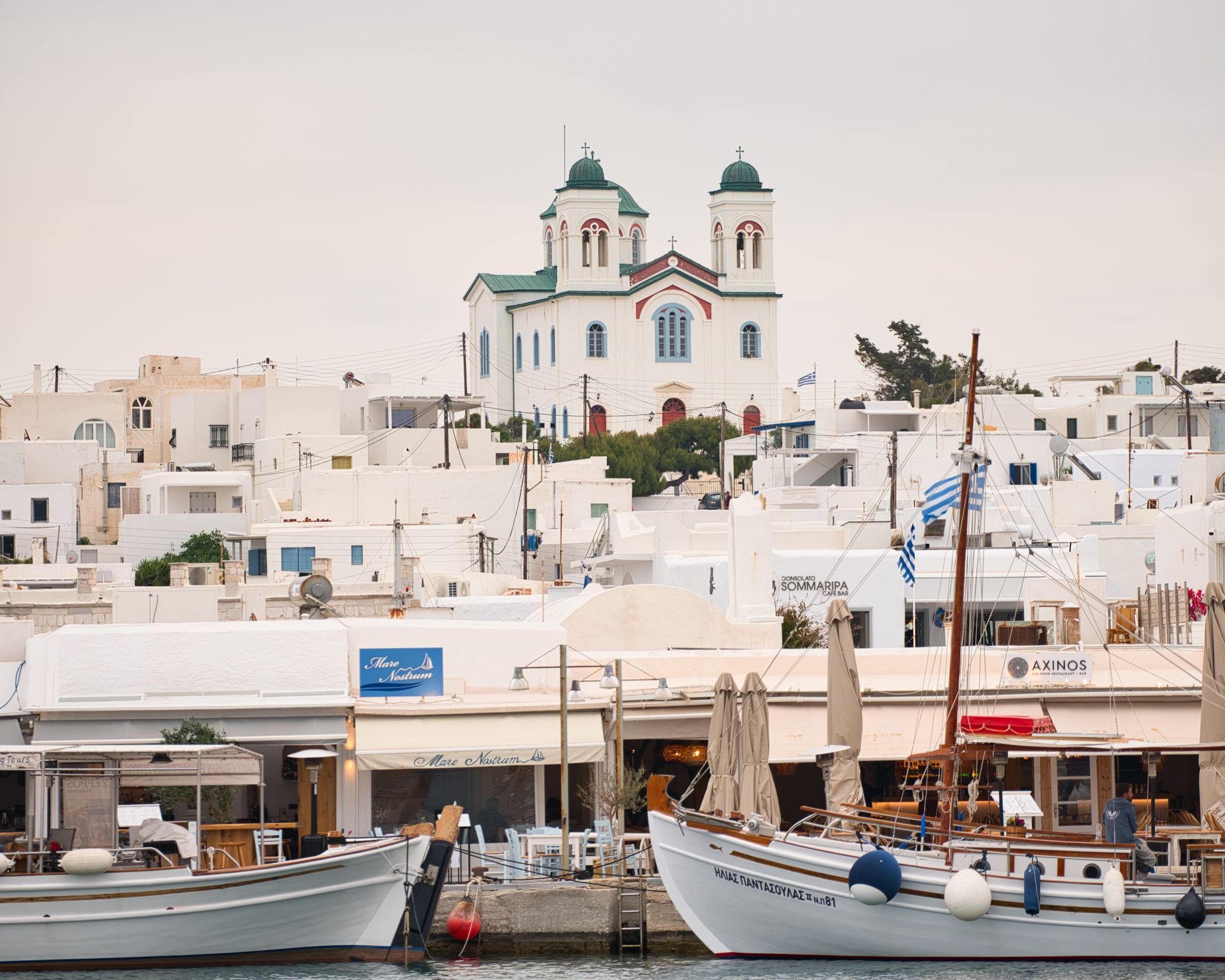 Paros view of church standing over city.