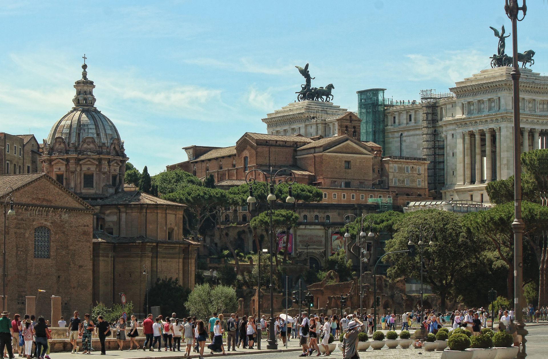 Vibrant view of Rome's iconic landmarks with bustling tourists, showcasing Italy's rich history and architecture.