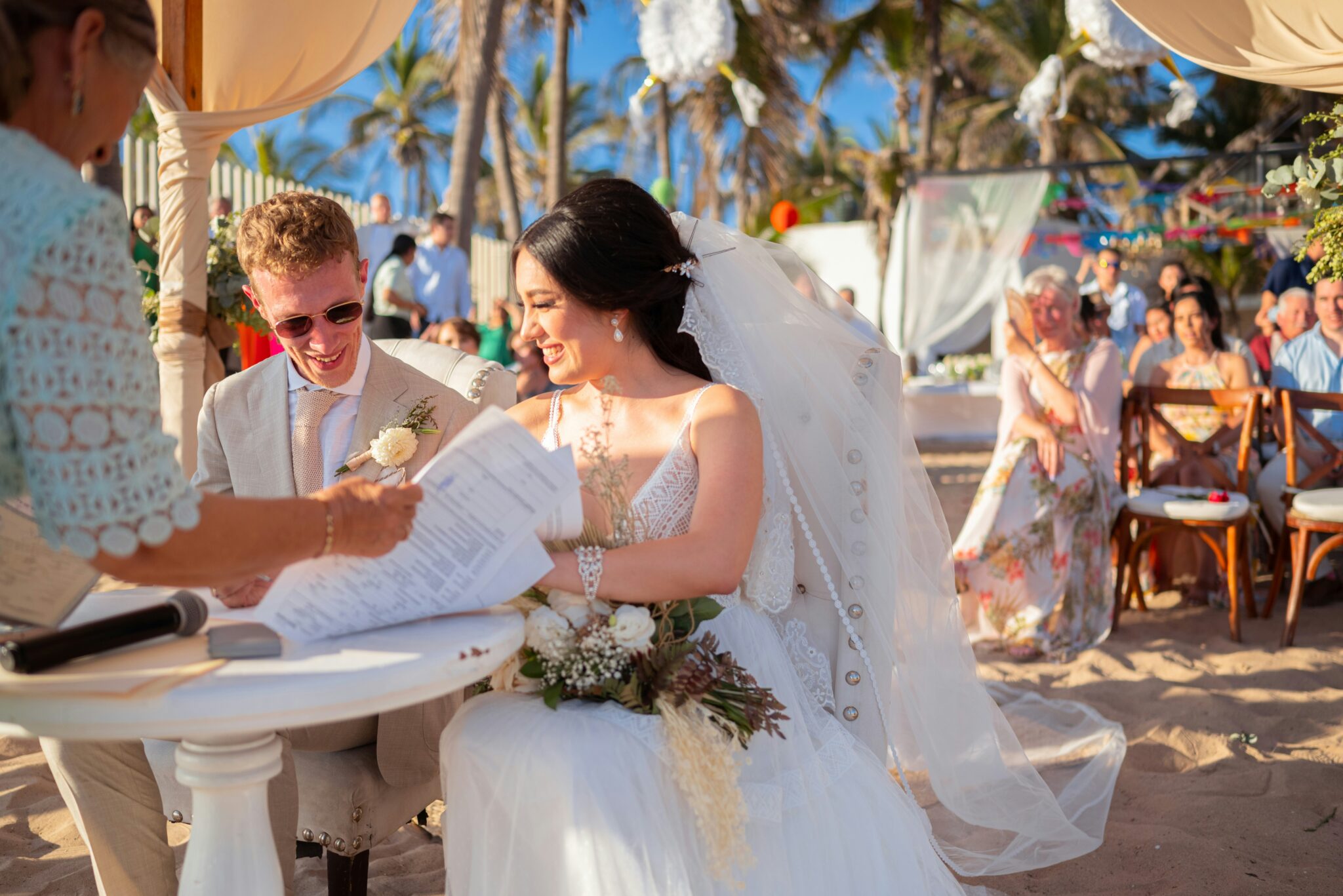 a couple signing documents on a beach
