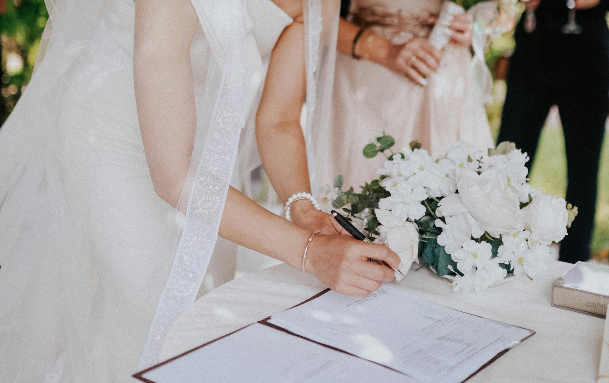 a bride signing a marriage certificate